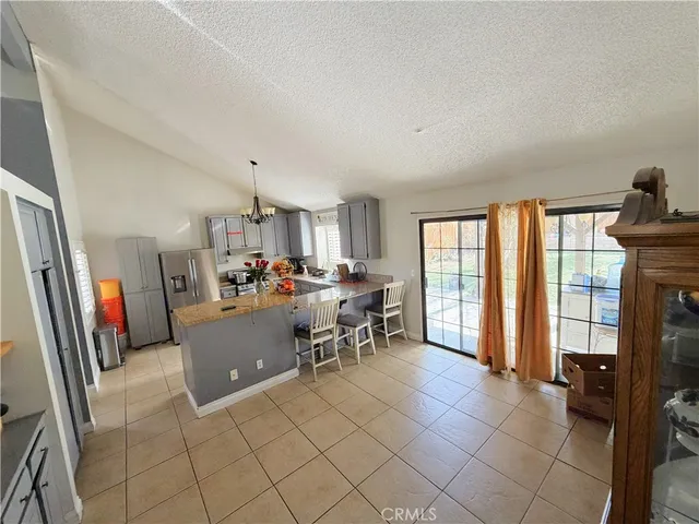 a living room with furniture a flat screen tv and a large window