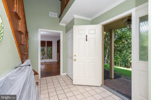 a view of an empty room with a fireplace and a window