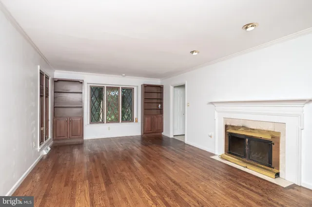 a kitchen with stainless steel appliances granite countertop a sink a stove and a wooden cabinets