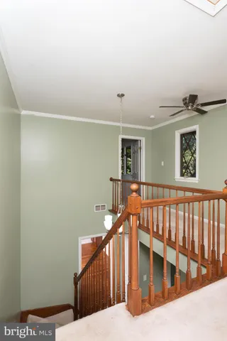 a view of a room with a ceiling fan