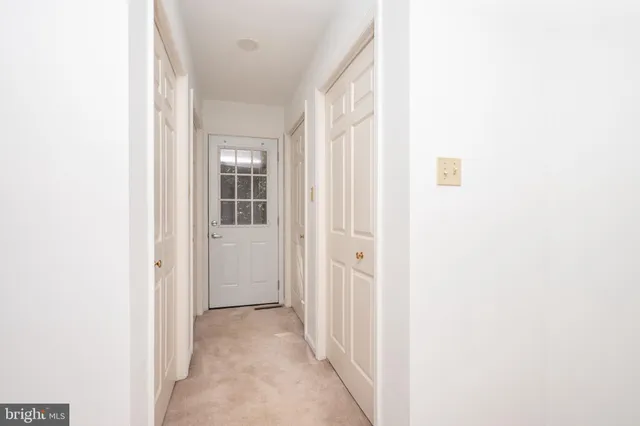 a bathroom with a granite countertop sink a toilet and a mirror