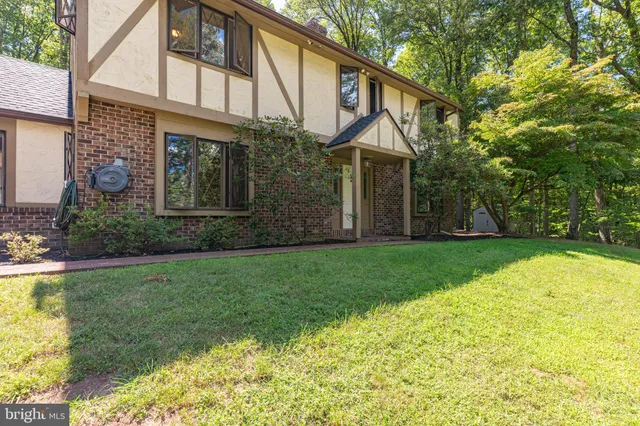 an empty room with wooden floor and fireplace