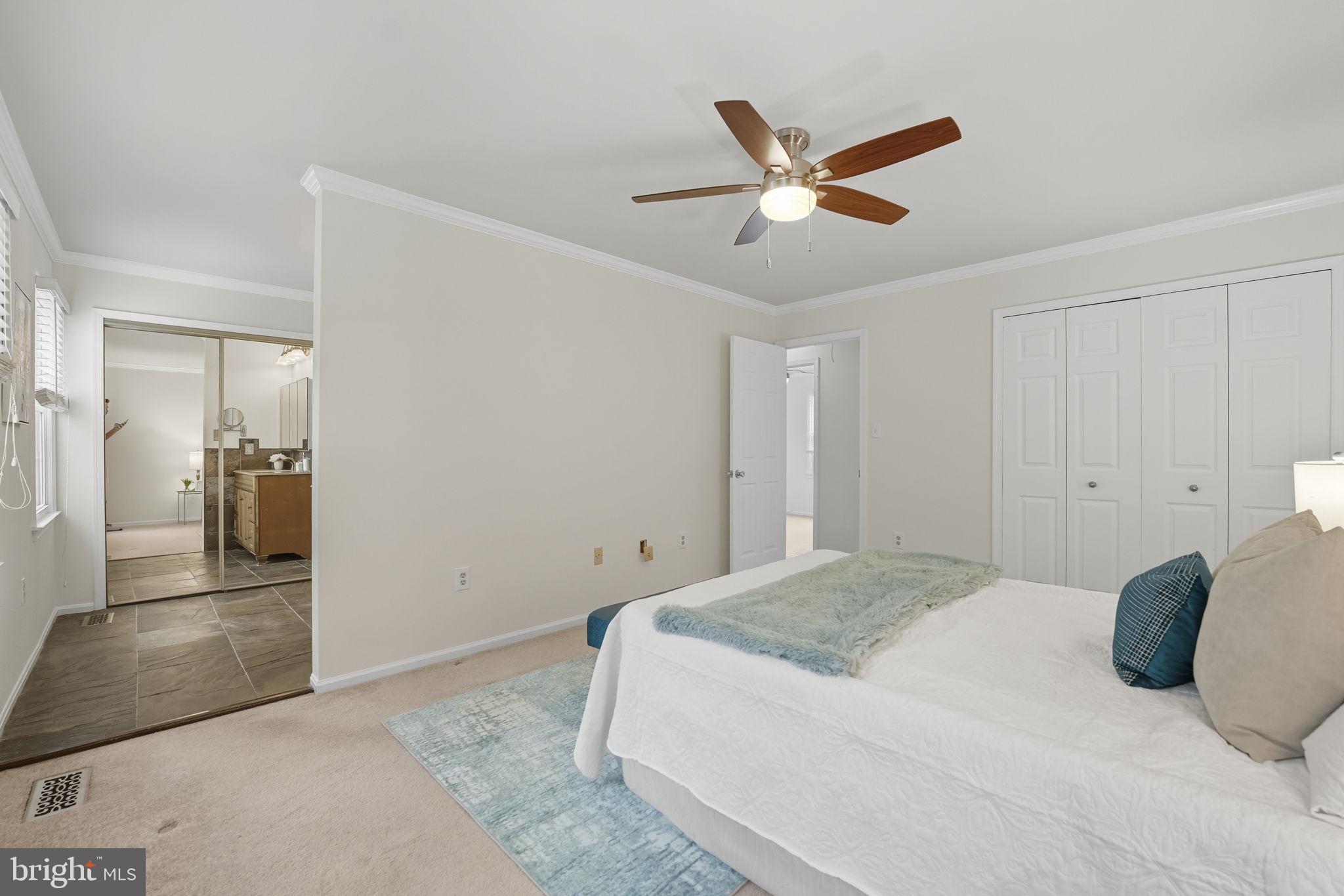 7954 Forest Path Way Springfield, VA 22153 - Photo 15 of 34 a bedroom with a large bed and a ceiling fan