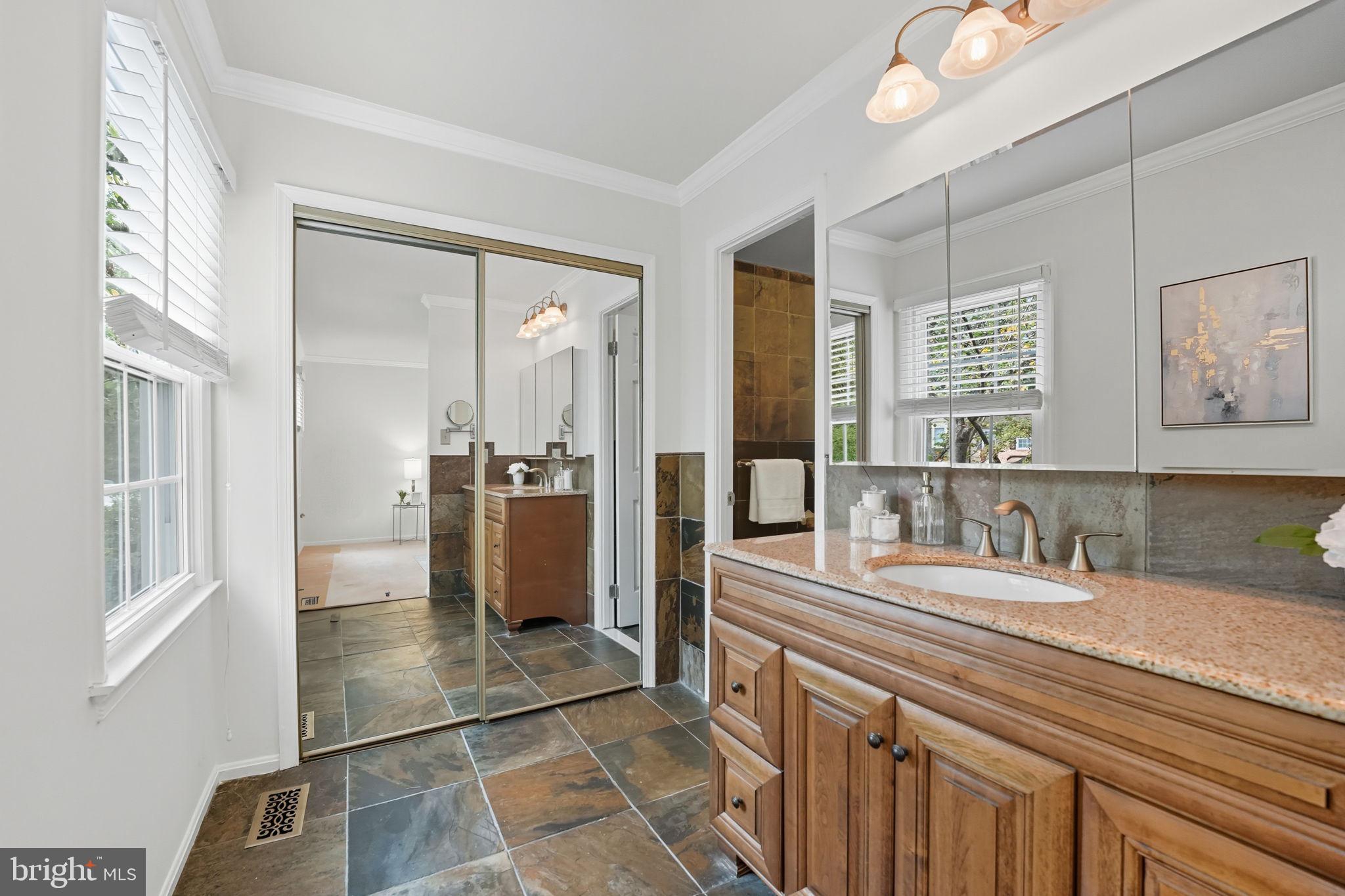 7954 Forest Path Way Springfield, VA 22153 - Photo 16 of 34 a bathroom with a sink a mirror and a shower