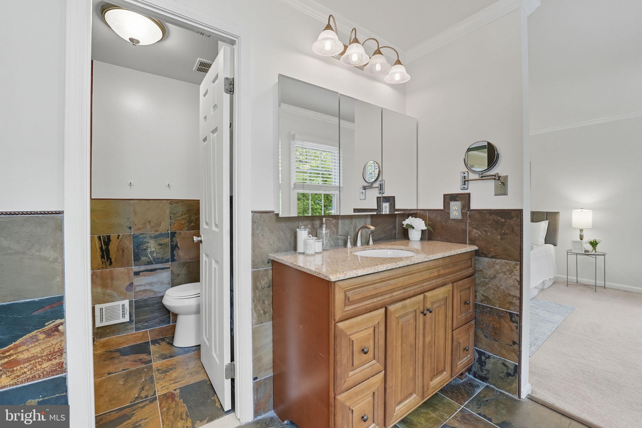 7954 Forest Path Way Springfield, VA 22153 - Photo 17 of 34 a bathroom with a sink a toilet and shower view