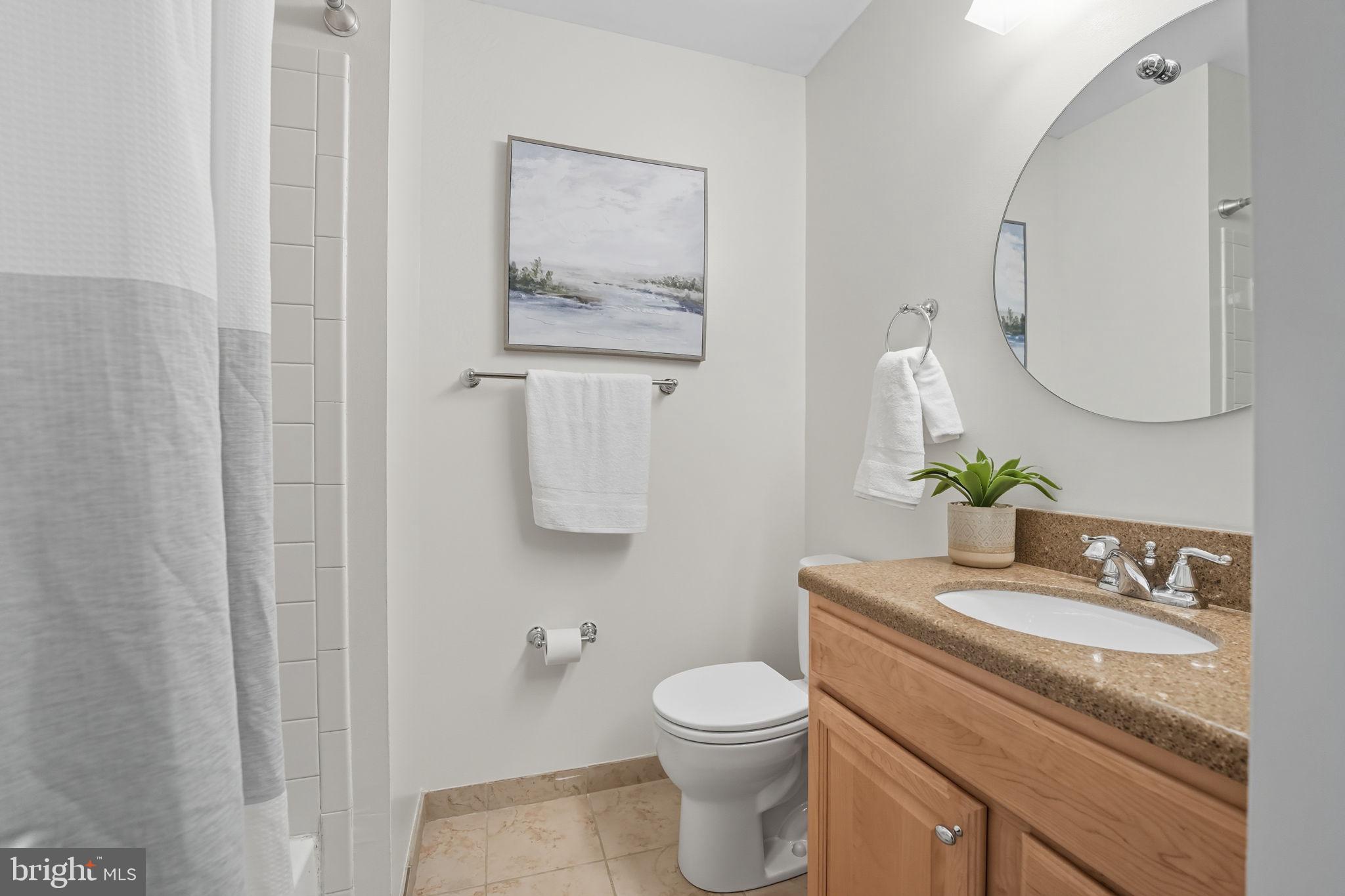 7954 Forest Path Way Springfield, VA 22153 - Photo 24 of 34 a bathroom with a granite countertop toilet sink and mirror