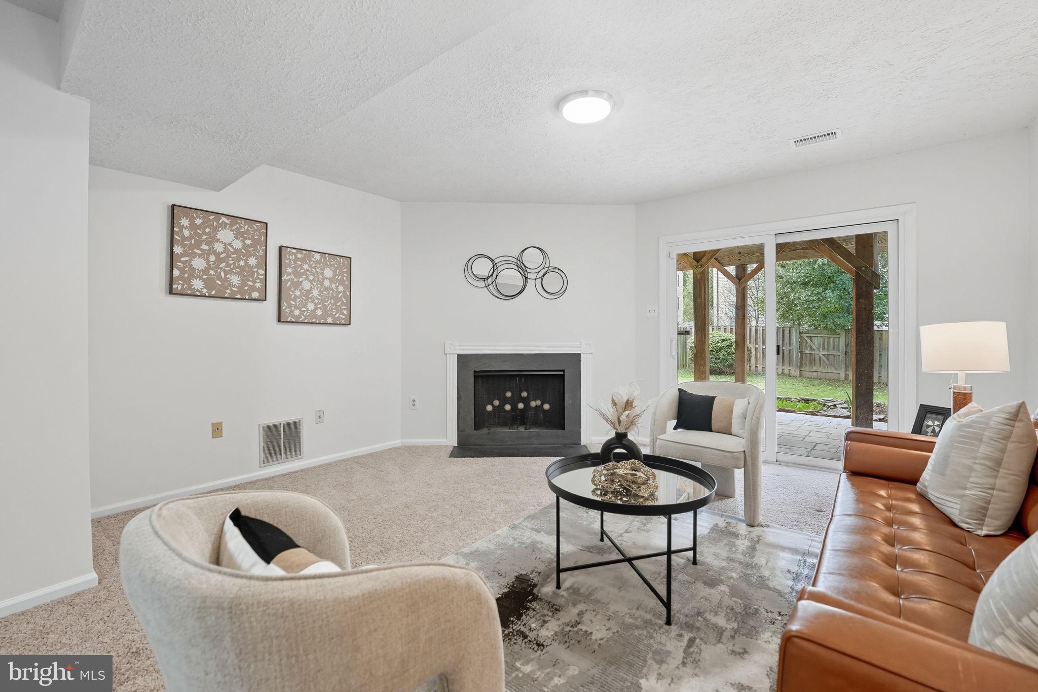 7954 Forest Path Way Springfield, VA 22153 - Photo 25 of 34 a living room with furniture and a fireplace