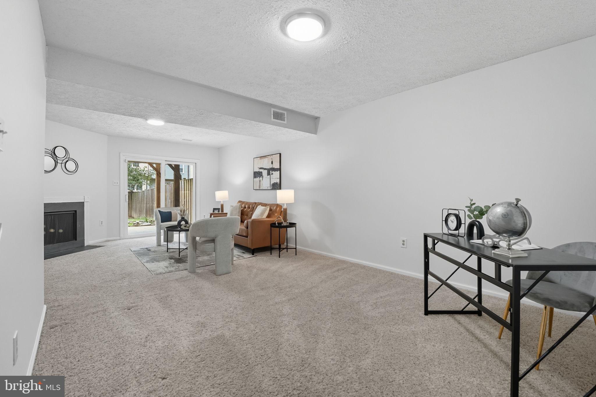 7954 Forest Path Way Springfield, VA 22153 - Photo 28 of 34 a living room with furniture and a fireplace
