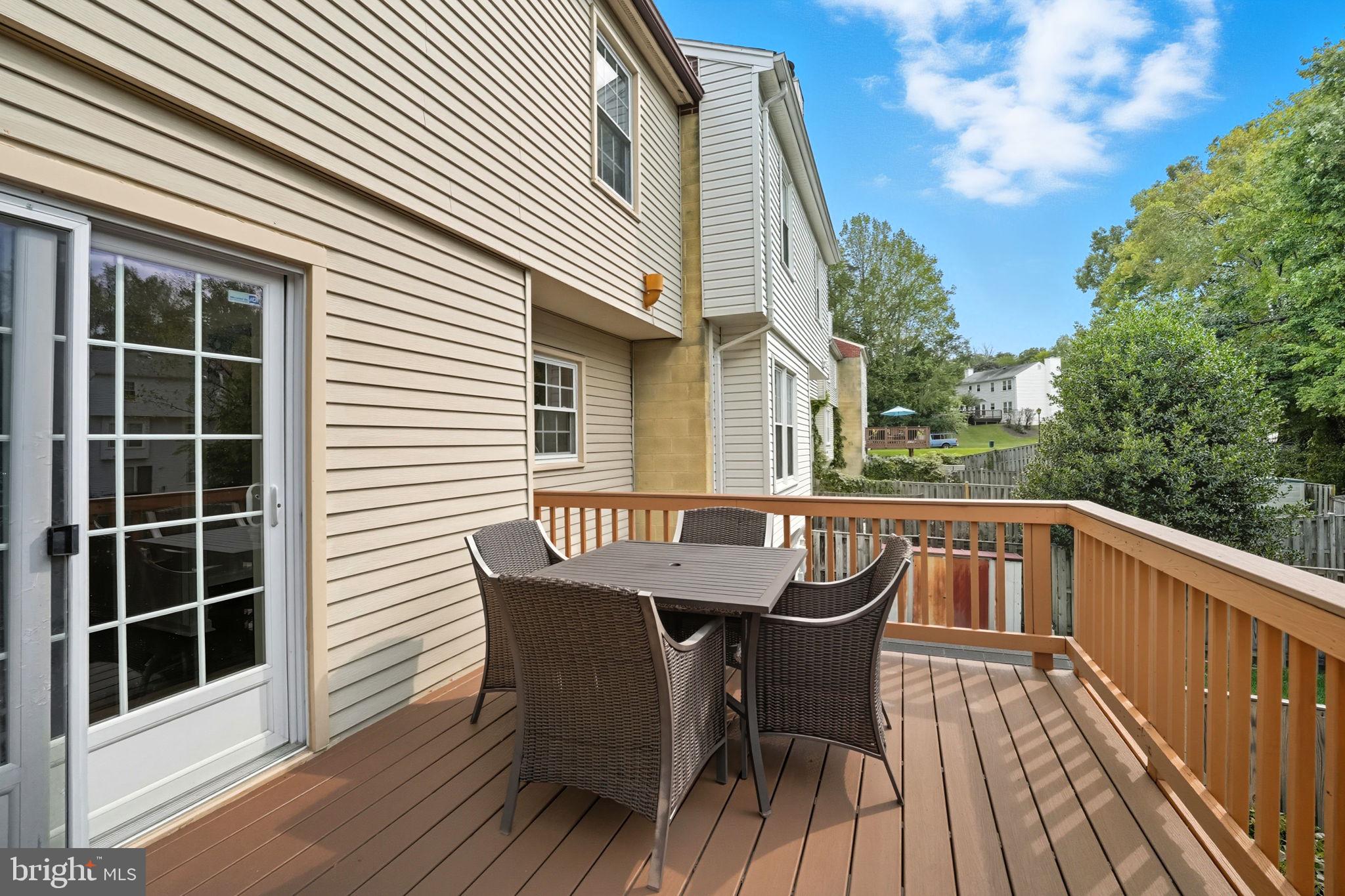 7954 Forest Path Way Springfield, VA 22153 - Photo 32 of 34 a roof deck with chairs and wooden fence
