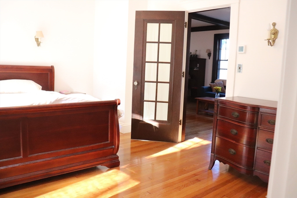 26 St Elmo Road Worcester, MA 01602 - Photo 12 of 42 a bedroom with a bed and wooden floor