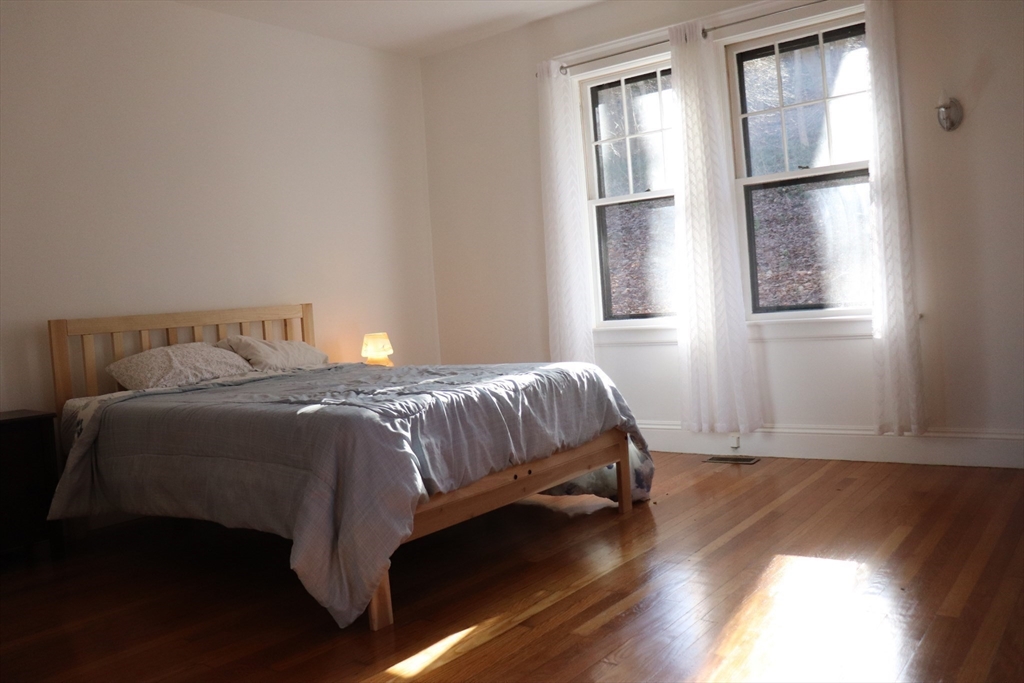 26 St Elmo Road Worcester, MA 01602 - Photo 15 of 42 a bedroom with a bed and wooden floor