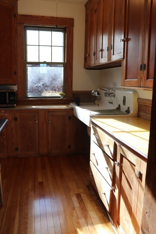 26 St Elmo Road Worcester, MA 01602 - Photo 19 of 42 a kitchen with stainless steel appliances granite countertop a sink a stove and a wooden floors