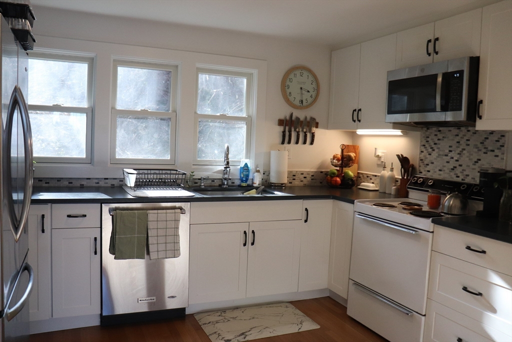 26 St Elmo Road Worcester, MA 01602 - Photo 26 of 42 a kitchen with a sink cabinets and window