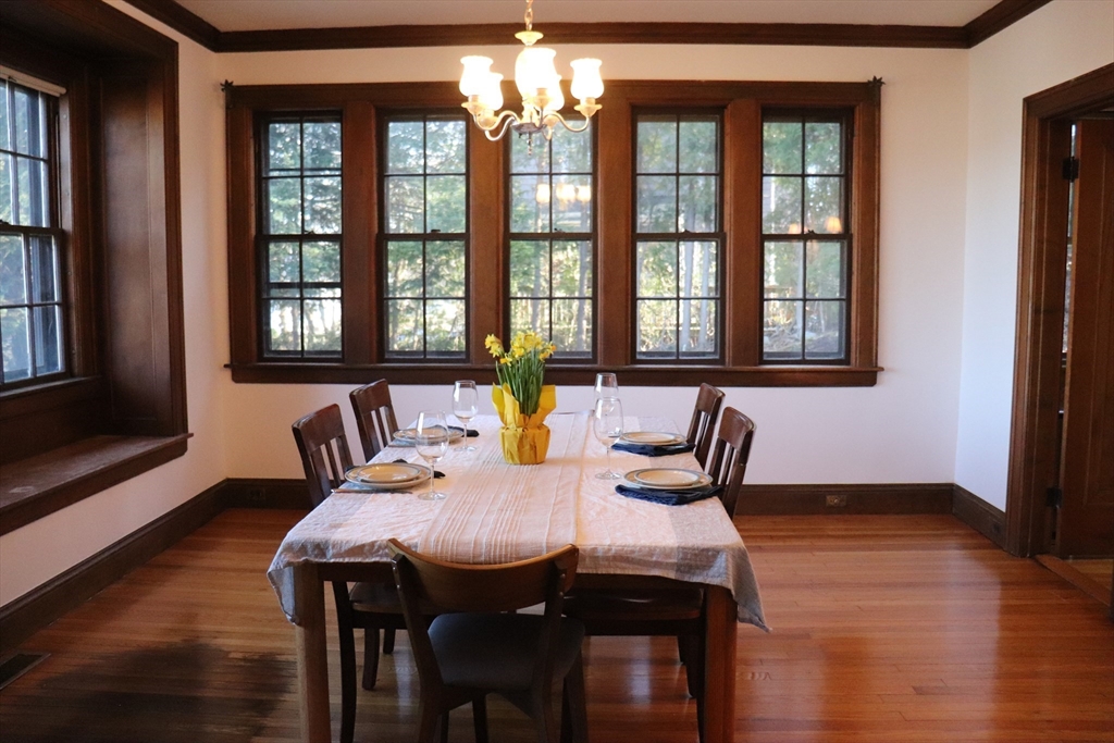 26 St Elmo Road Worcester, MA 01602 - Photo 3 of 42 a view of a dining room with furniture wooden floor and chandelier