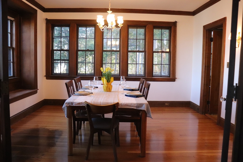 26 St Elmo Road Worcester, MA 01602 - Photo 7 of 42 a view of a dining room with furniture a chandelier and wooden floor
