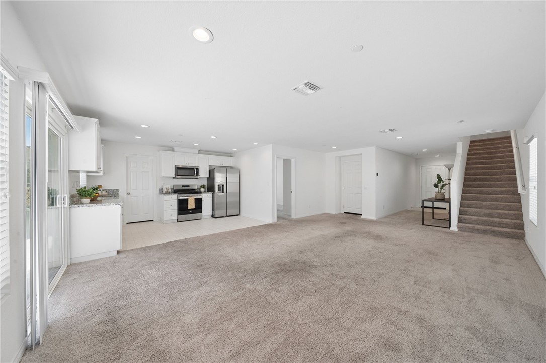 20130 Curaco Court Riverside, CA 92507 - Photo 12 of 43 Open-concept main level connecting the kitchen, living area, and staircase.