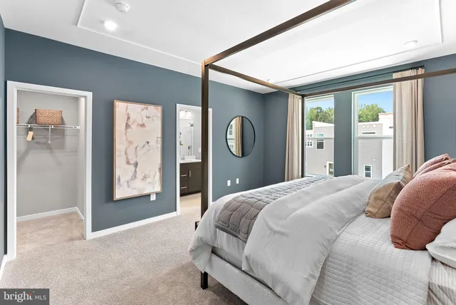 a bedroom with a large bed and a chandelier