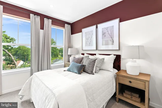 a bed sitting in a bedroom next to a window