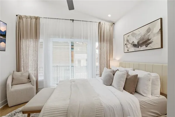 a bedroom with a bed and a painting on the wall