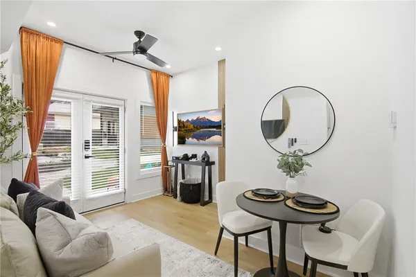 a living room with furniture a rug and a mirror