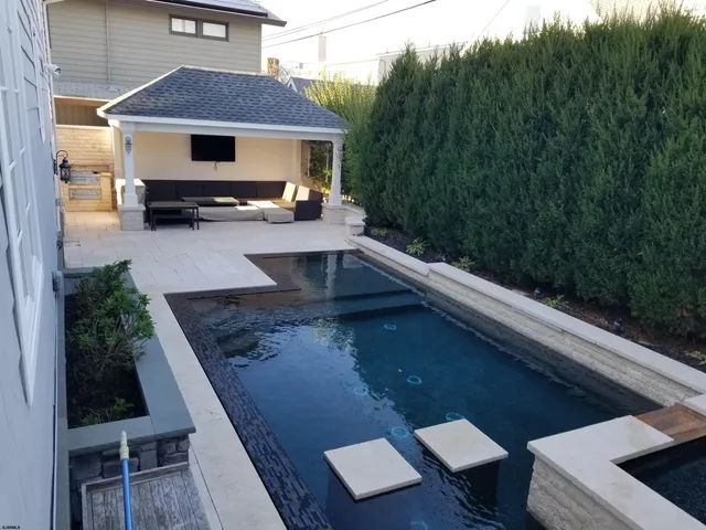 a kitchen with stainless steel appliances granite countertop a stove oven and a refrigerator with white cabinets