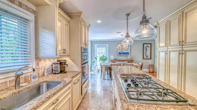 a bathroom with a granite countertop sink a toilet and a shower