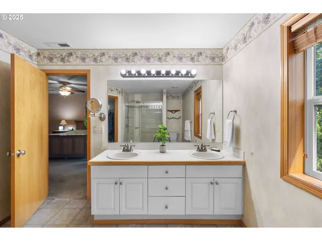 a spacious bathroom with a granite countertop sink and a mirror
