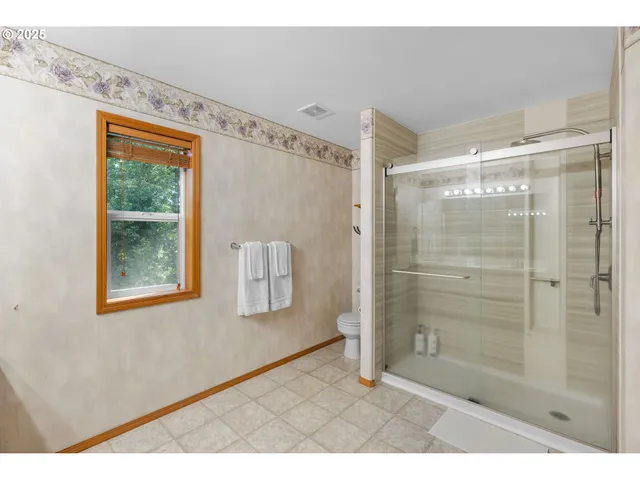 a bathroom with a shower and a mirror