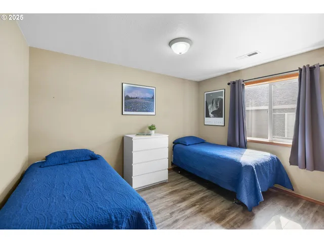 a bedroom with a bed and a large window