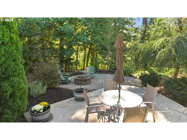 a backyard of a house with table and chairs