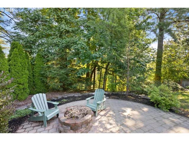 a view of backyard with outdoor seating and green space