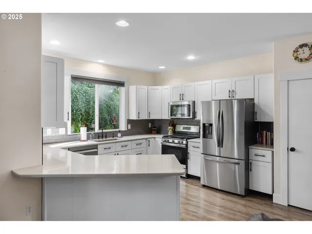a kitchen with refrigerator and cabinets