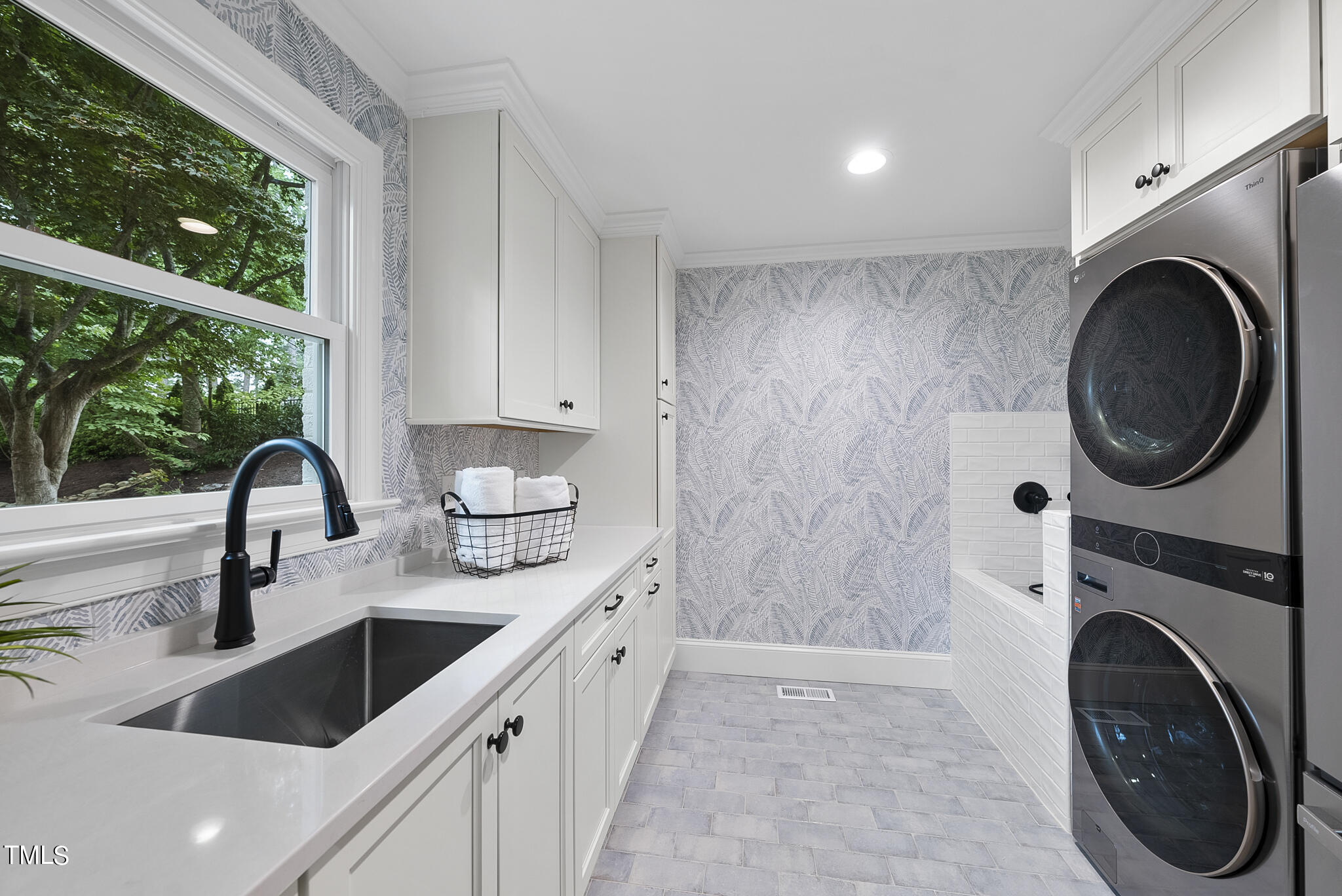 1704 Hunting Ridge Road Raleigh, NC 27615 - Photo 21 of 46 a kitchen with a sink a washer and dryer next to a window