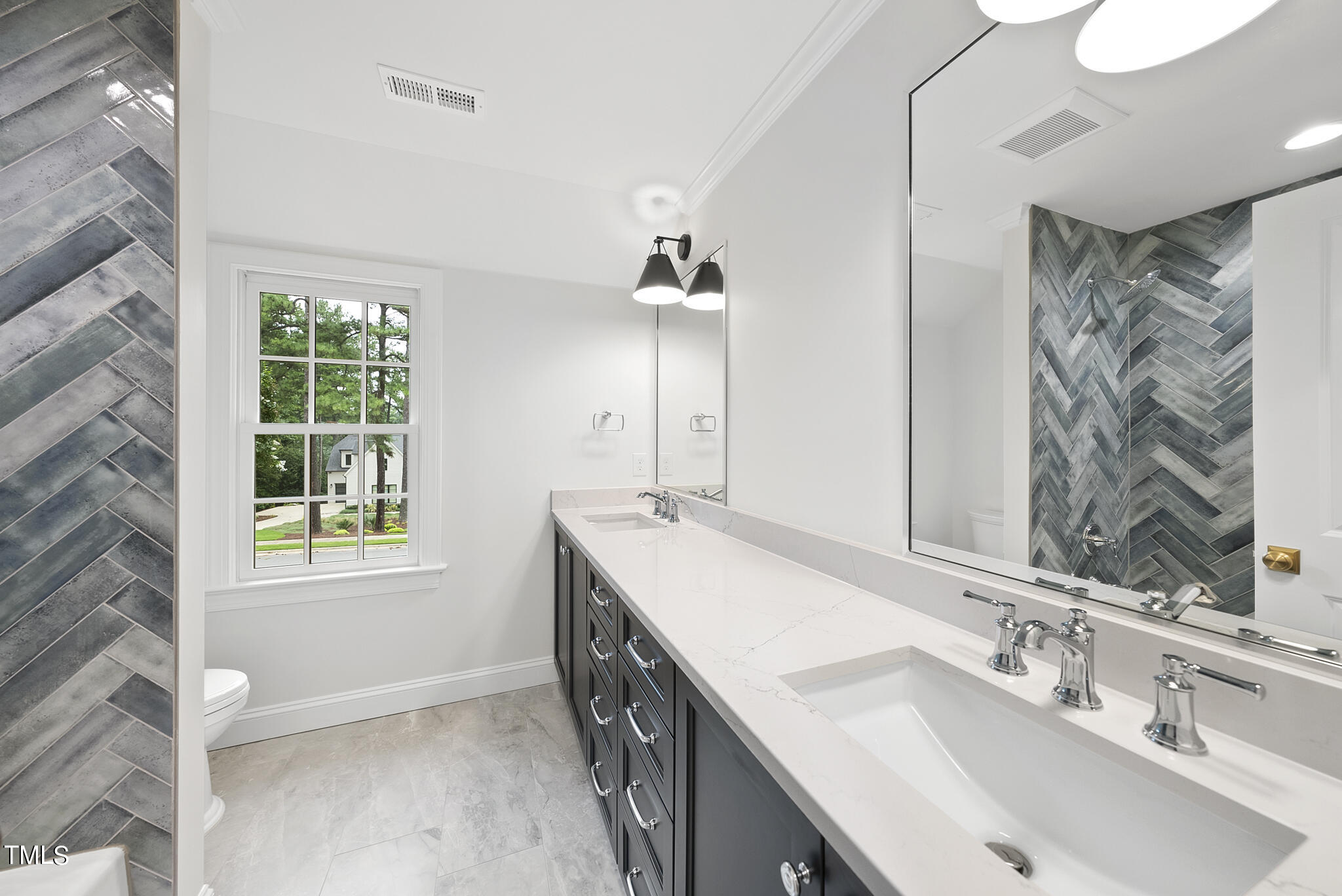 1704 Hunting Ridge Road Raleigh, NC 27615 - Photo 32 of 46 a bathroom with a sink double vanity and a mirror