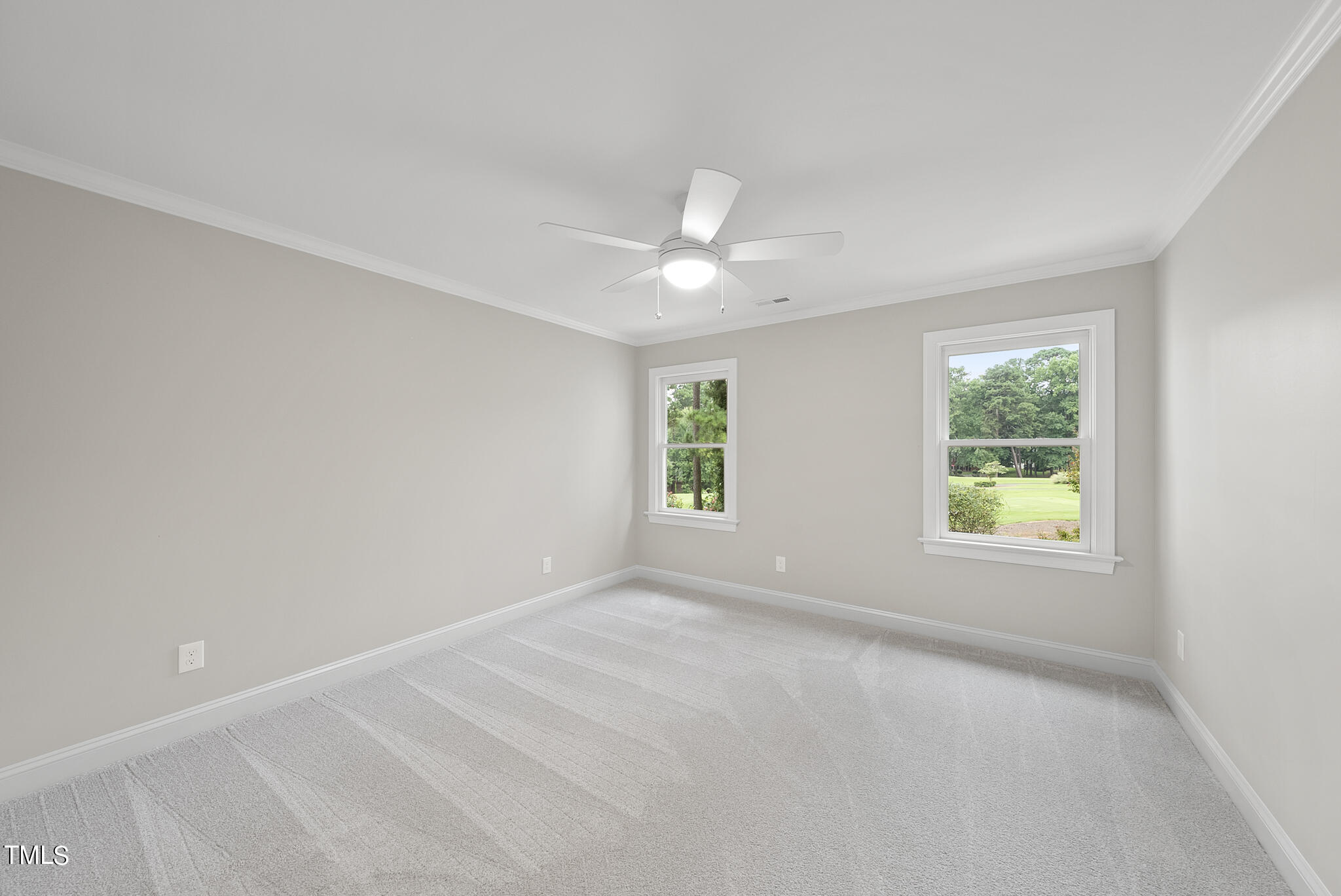 1704 Hunting Ridge Road Raleigh, NC 27615 - Photo 35 of 46 an empty room with a window and a fan