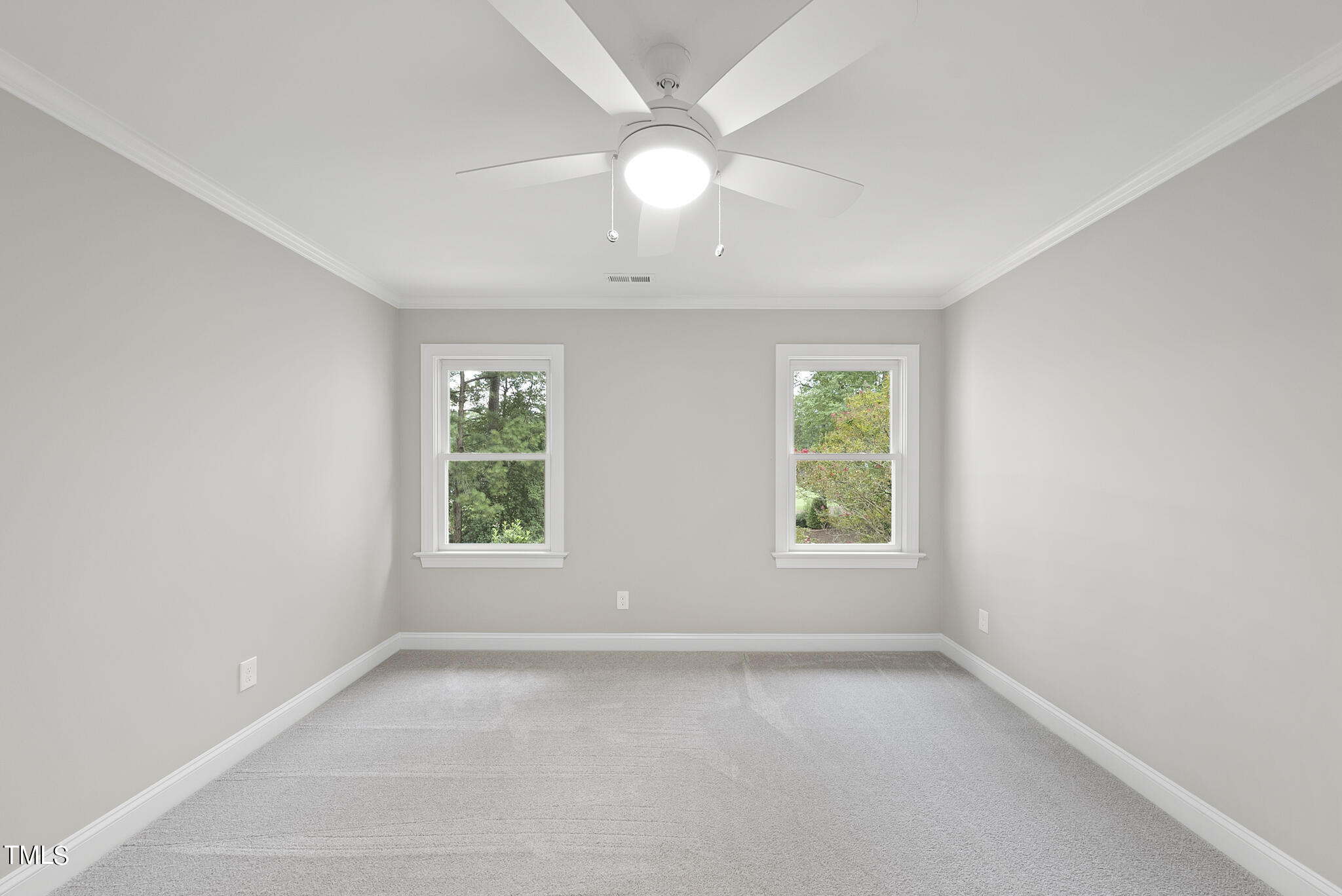 1704 Hunting Ridge Road Raleigh, NC 27615 - Photo 36 of 46 an empty room with a window and a fan