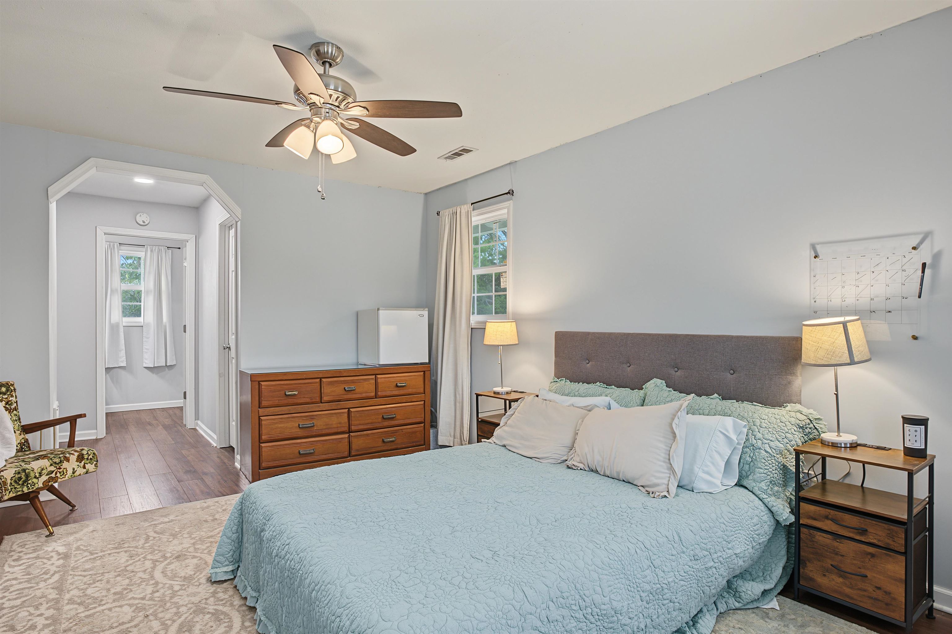 246 Cherryville Road Bells, TN 38006 - Photo 25 of 31 Recessed archway entry, ceiling fan with integrated lighting, wood-finish flooring, and a large window