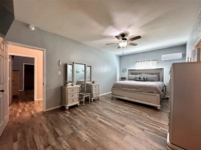 a bedroom with a bed couch and a window