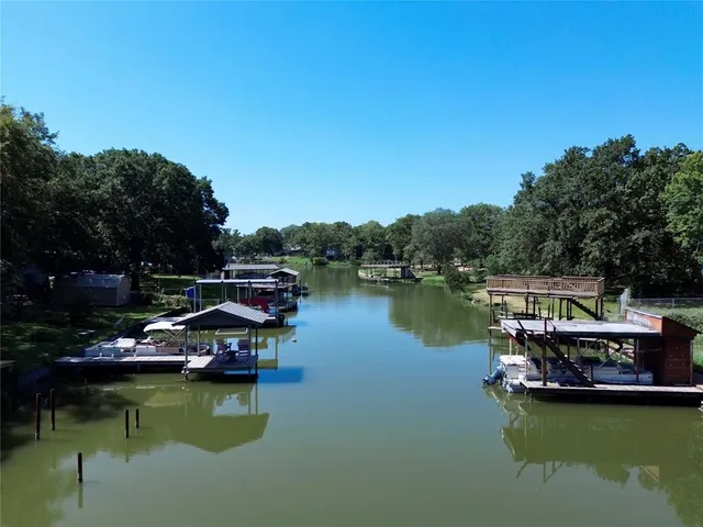 a view of a lake with boats and trees in the background