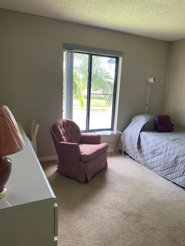 a spacious bedroom with a bed and a couch