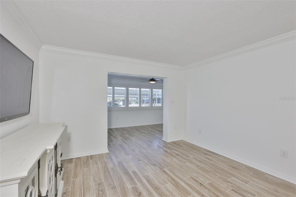 4736 Jasper Drive, Unit 103 New Port Richey, FL 34652 - Photo 17 of 41 a view of an empty room with wooden floor and a window