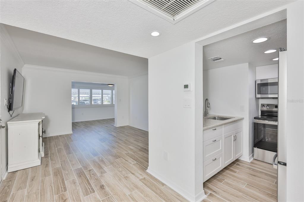 4736 Jasper Drive, Unit 103 New Port Richey, FL 34652 - Photo 18 of 41 a view of kitchen with wooden floor and electronic appliances