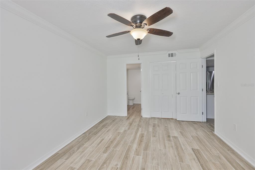 4736 Jasper Drive, Unit 103 New Port Richey, FL 34652 - Photo 19 of 41 an empty room with wooden floor and windows