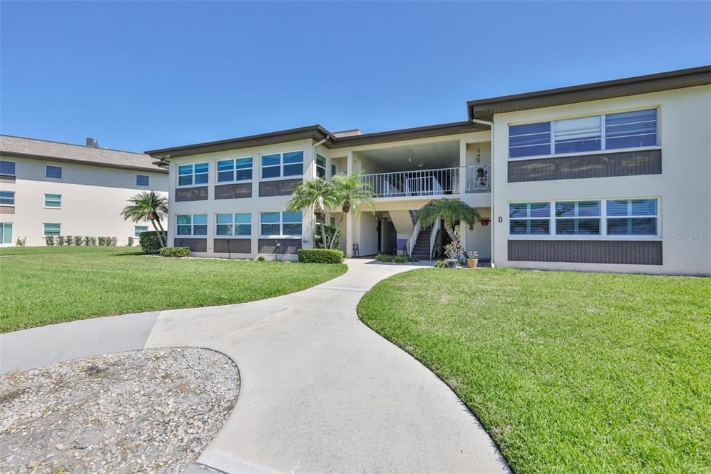 4736 Jasper Drive, Unit 103 New Port Richey, FL 34652 - Photo 2 of 41 front view of a house with a yard