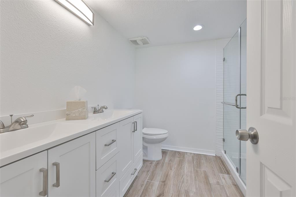 4736 Jasper Drive, Unit 103 New Port Richey, FL 34652 - Photo 21 of 41 a bathroom with a sink a toilet and a shower