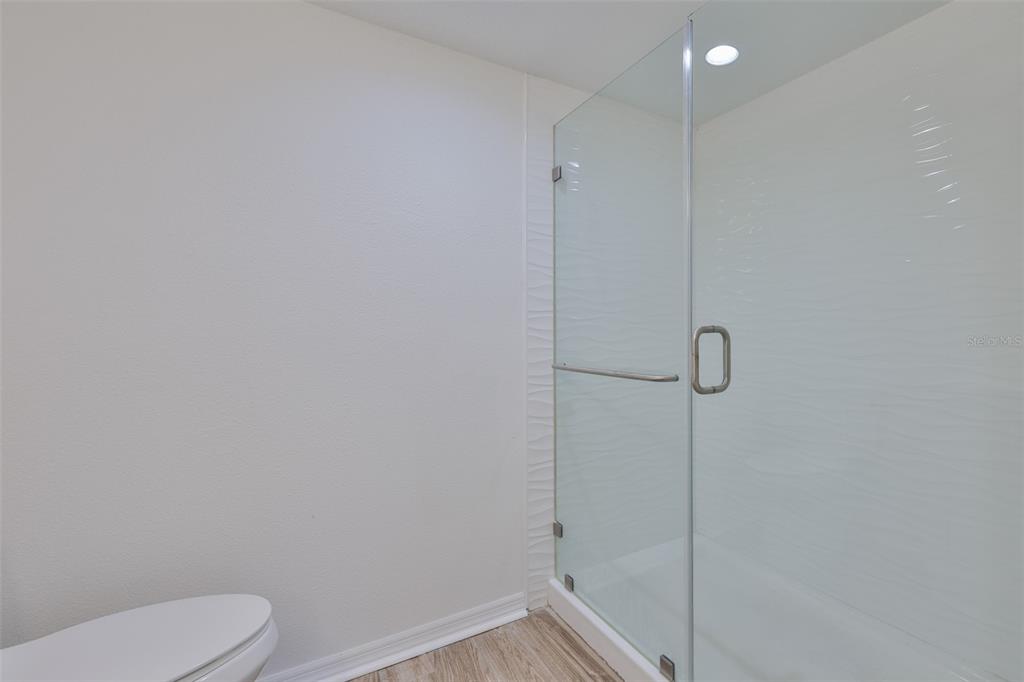 4736 Jasper Drive, Unit 103 New Port Richey, FL 34652 - Photo 22 of 41 a bathroom with a shower and toilet