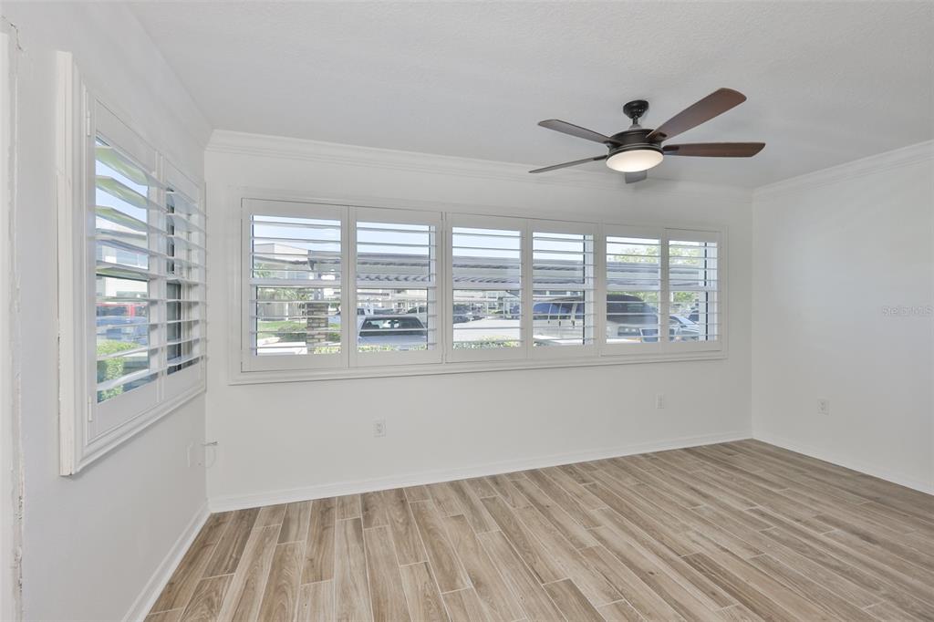 4736 Jasper Drive, Unit 103 New Port Richey, FL 34652 - Photo 26 of 41 a view of empty room with wooden floor and fan