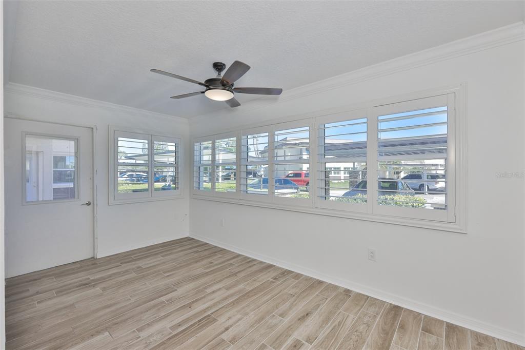 4736 Jasper Drive, Unit 103 New Port Richey, FL 34652 - Photo 27 of 41 a view of an empty room with a window and wooden floor