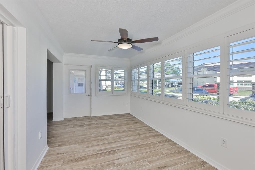 4736 Jasper Drive, Unit 103 New Port Richey, FL 34652 - Photo 28 of 41 wooden floor in an empty room with a window