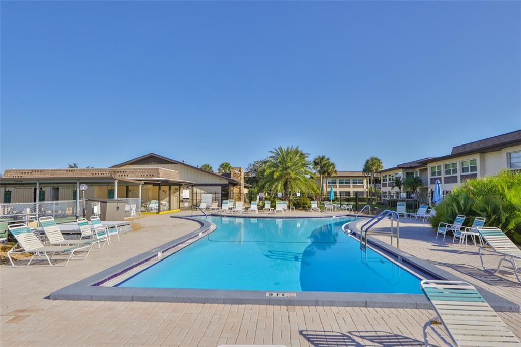 4736 Jasper Drive, Unit 103 New Port Richey, FL 34652 - Photo 40 of 41 a view of a swimming pool with outdoor seating